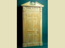 Limed pine Hallidays' door with heavily carved architrave and pediment